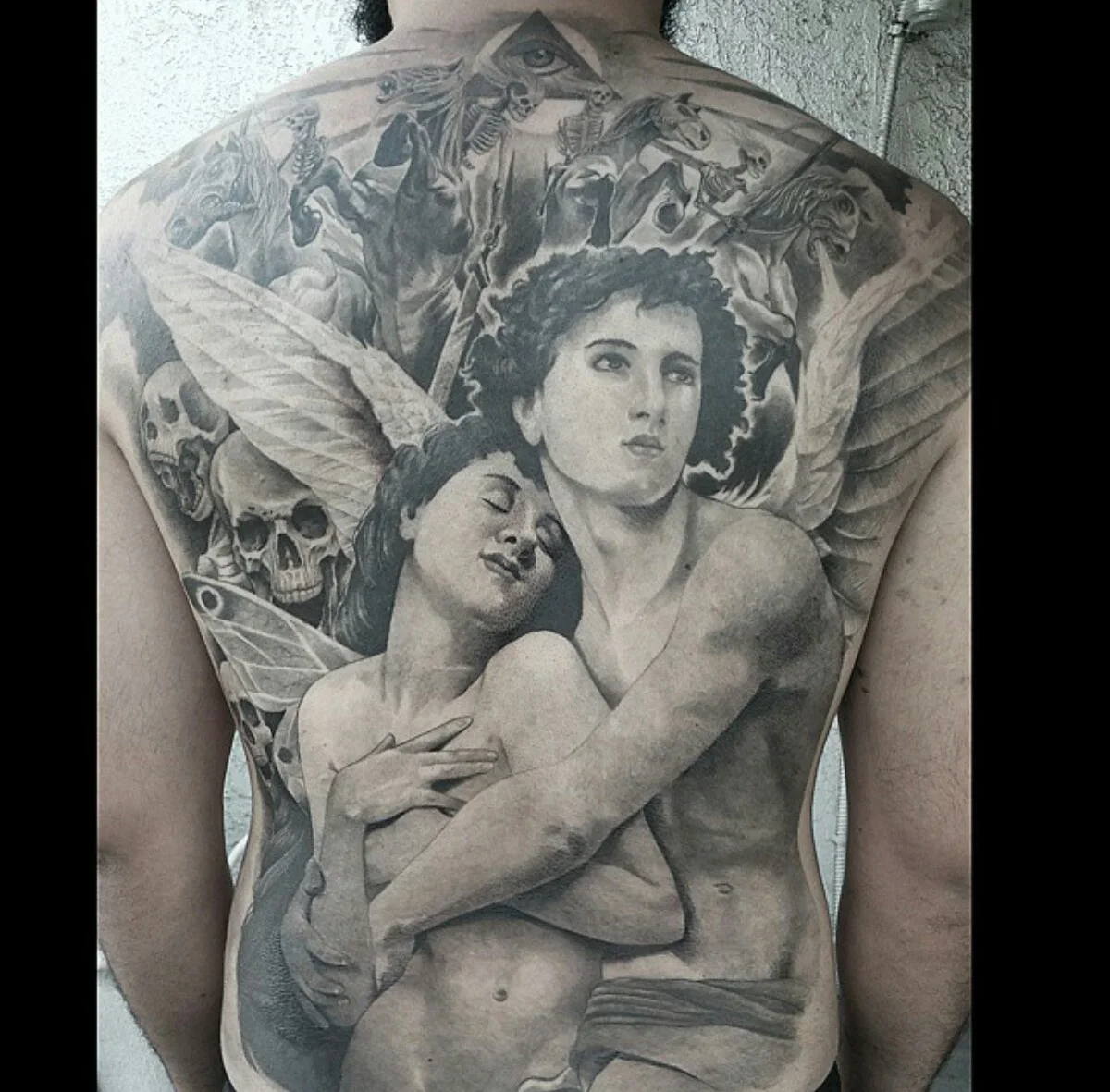 Black-and-grey back tattoo with classical figures