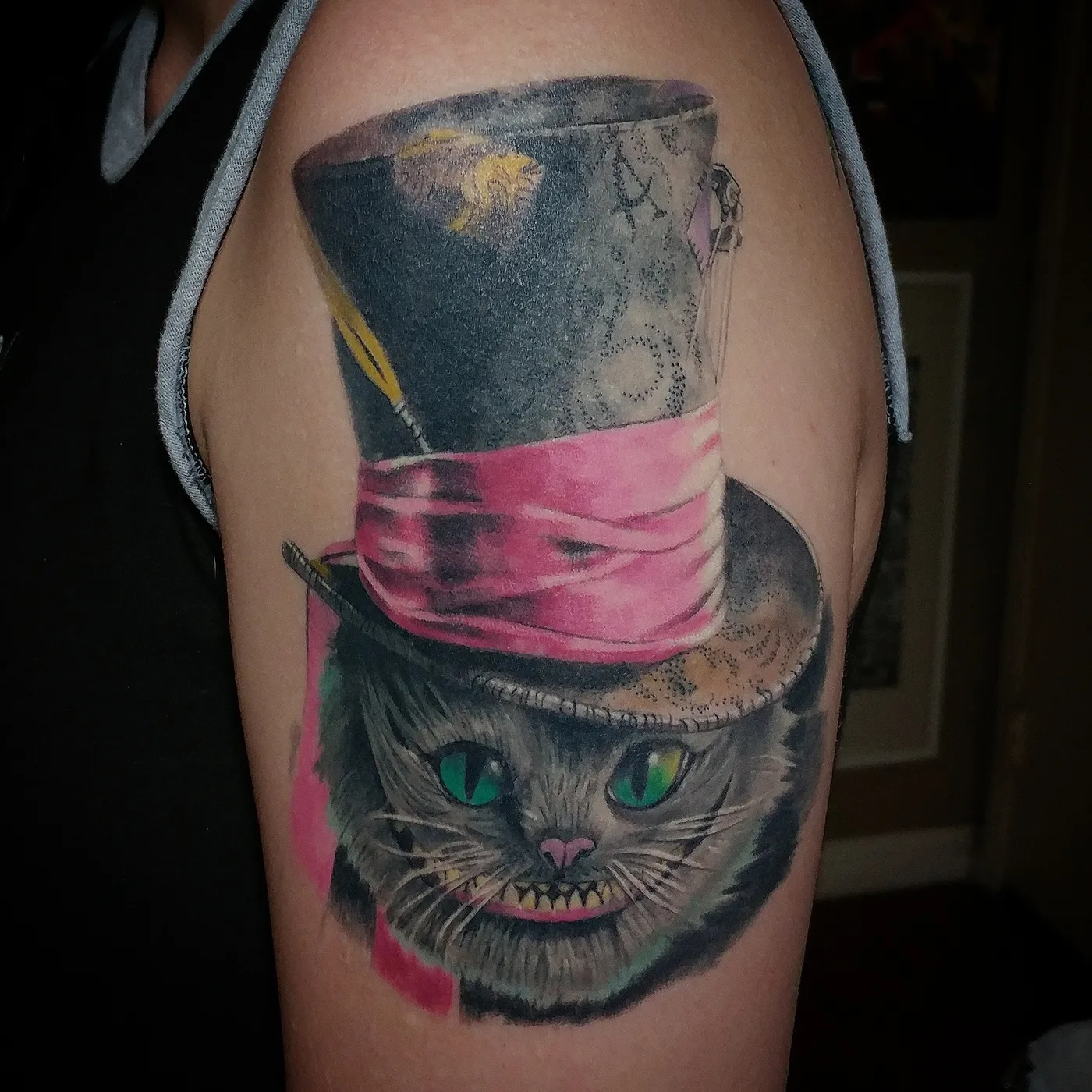 Color tattoo of a cat in a pink top hat