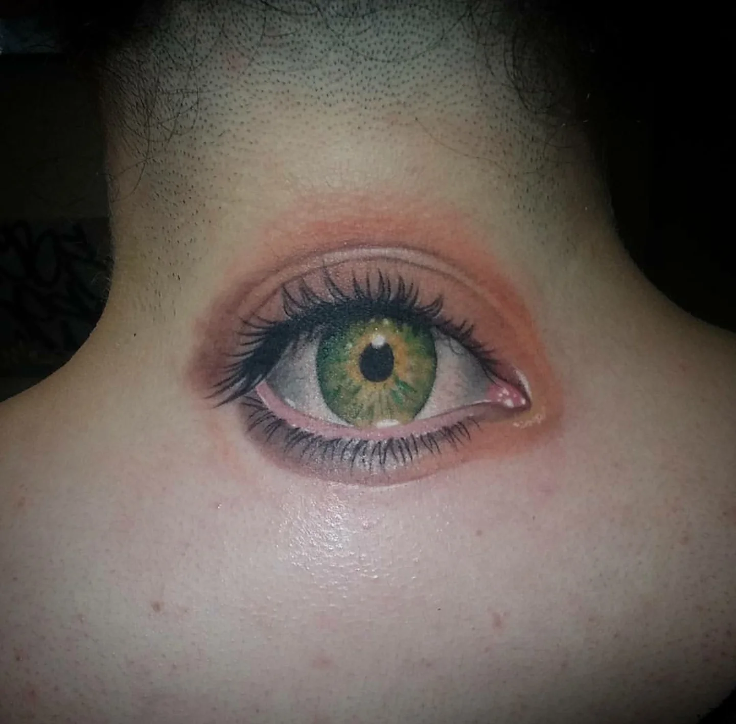 Realistic green eye tattoo